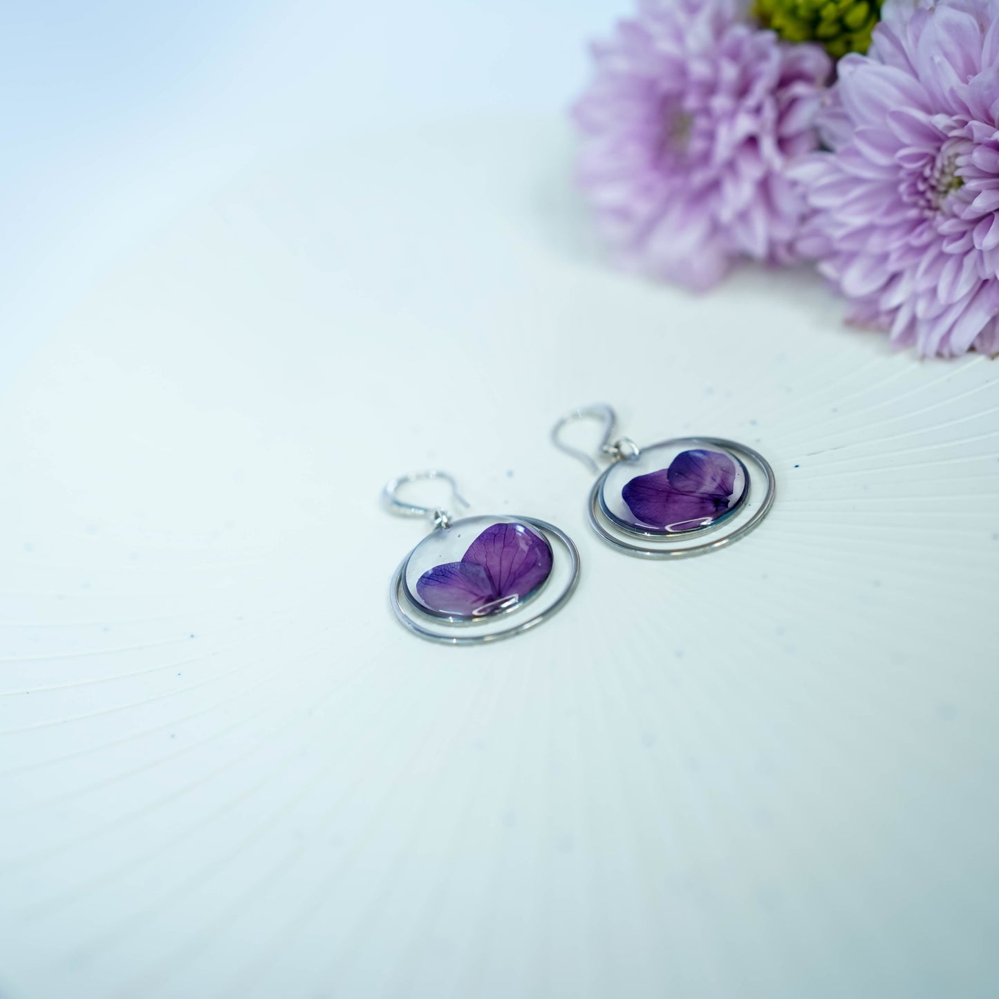 Pair of Erstella flower earrings styled with a minimal outfit for everyday wear.