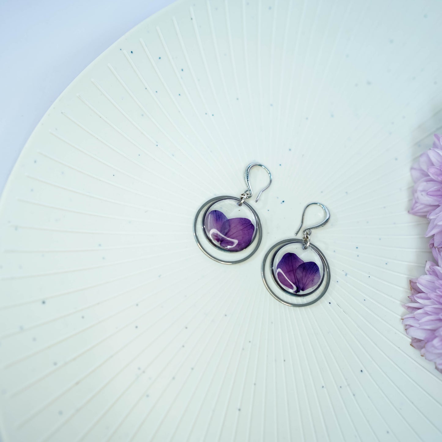 Pair of Erstella flower earrings styled with a minimal outfit for everyday wear.