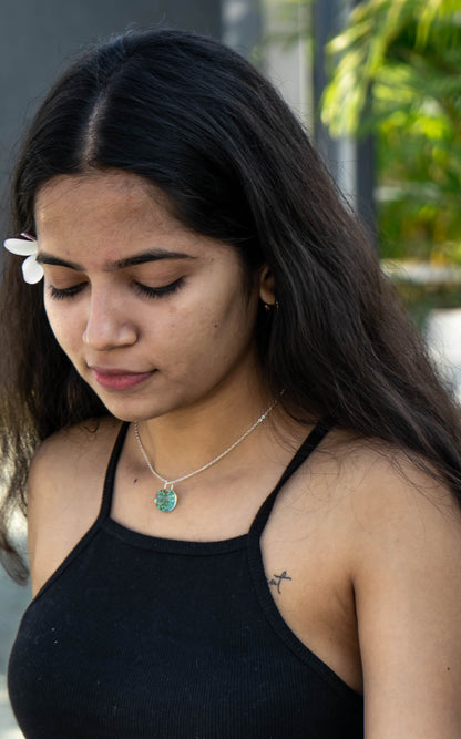 A collection of handmade resin art pendants, showcasing intricate floral designs preserved in clear resin, attached to delicate necklaces.