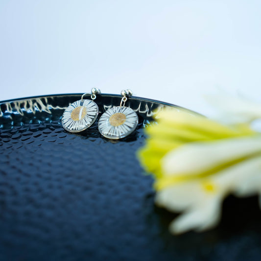 Pair of Erstella flower earrings styled with a minimal outfit for everyday wear.