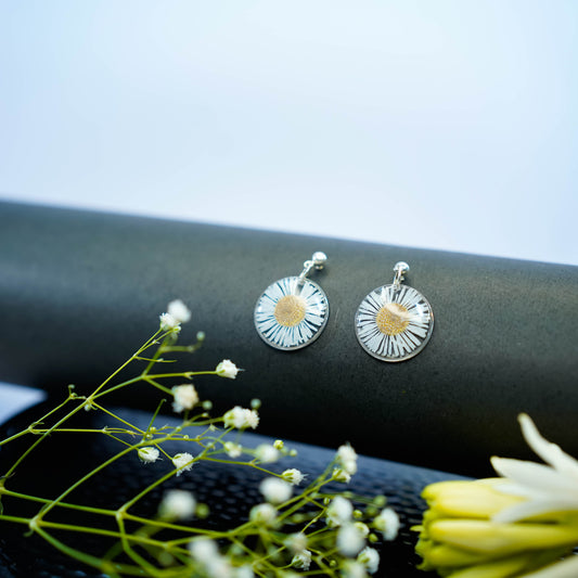 Pair of Erstella flower earrings styled with a minimal outfit for everyday wear.