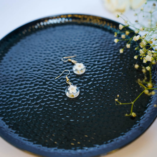 Pair of Erstella flower earrings styled with a minimal outfit for everyday wear.