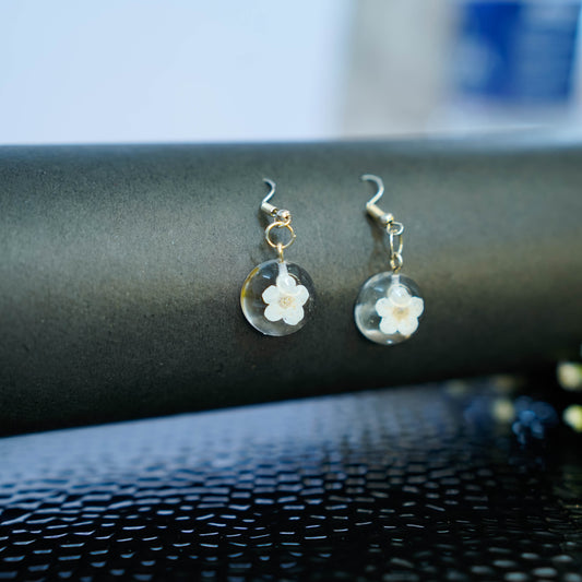 Pair of Erstella flower earrings styled with a minimal outfit for everyday wear.