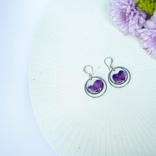 Pair of Erstella flower earrings styled with a minimal outfit for everyday wear.