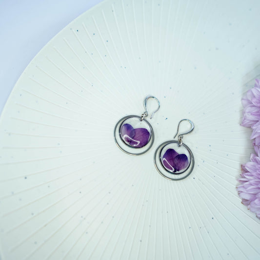 Pair of Erstella flower earrings styled with a minimal outfit for everyday wear.
